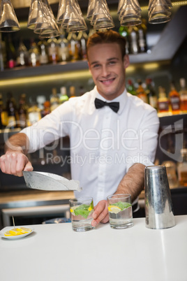 Happy bartender making a cocktail