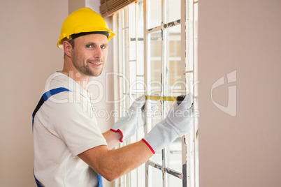 Construction worker using measuring tape