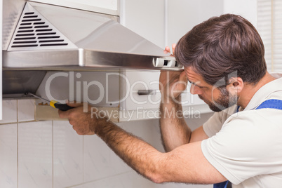 Handyman fixing the oven