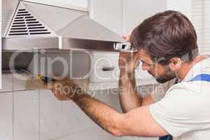 Handyman fixing the oven