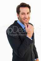 Businessman touching his chin while smiling at camera