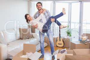 Cute couple unpacking cardboard boxes