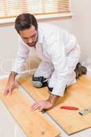 Carpenter putting down new wooden planks