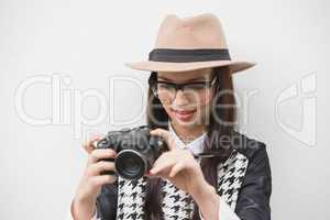 Pretty hipster looking at her camera