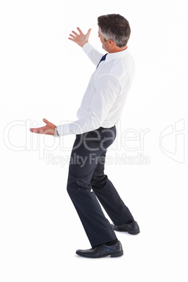 Businessman without his jacket posing with arms out