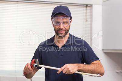 Plumber fixing pipe with wrench