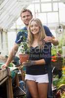 Cute couple gardening in greenhouse