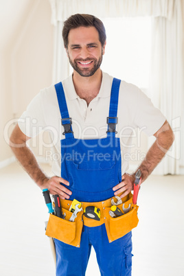 Handyman smiling at camera in tool belt