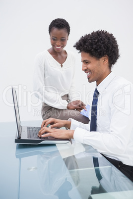 Smiling designer team using laptop