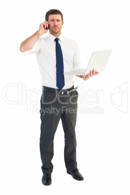 Businessman on the phone holding laptop