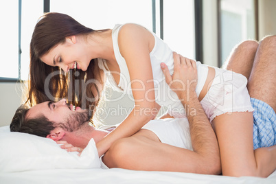 Young couple having fun in bed