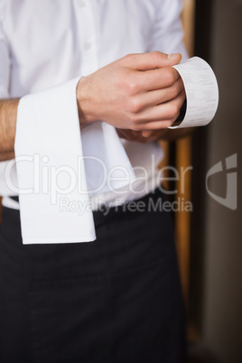 Handsome waiter reading a receipt