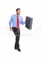 Businessman walking while holding briefcase