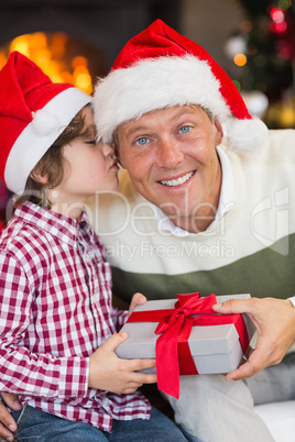 Son kissing his father after receiving a christmas gift