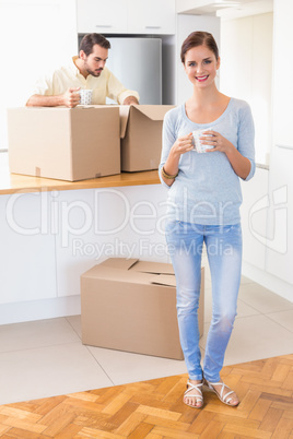 Young couple unpacking boxes in kitchen