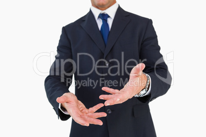 Mid section of a businessman with arms out