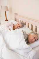 Senior couple sleeping in bed