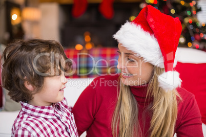 Festive mother and son smiling at each other