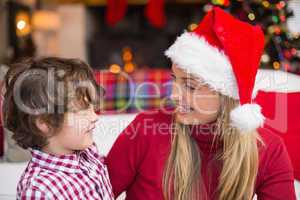 Festive mother and son smiling at each other