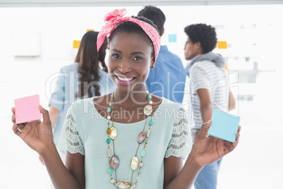 Young creative woman showing cards