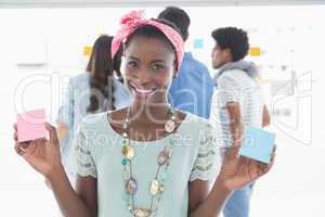 Young creative woman showing cards