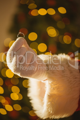 Hand of santa holding engagement ring