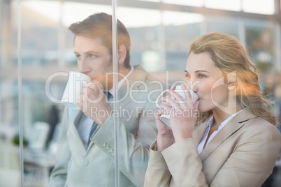 Business people drinking cup of coffee through the window