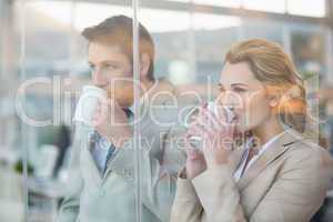 Business people drinking cup of coffee through the window