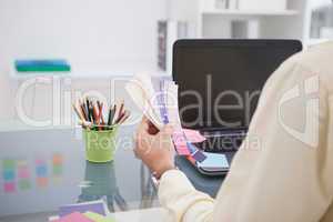 Designer working at his desk with colour sample