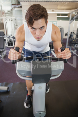 Fit man working out on the exercise bike