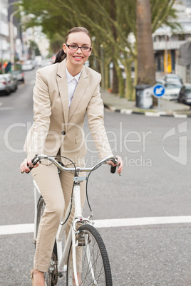 Young businesswoman riding her bike