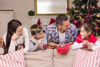 Smiling family leaning on the couch