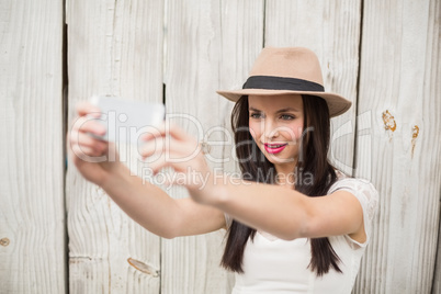 Pretty brunette taking a selfie