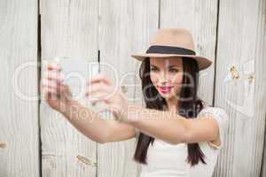 Pretty brunette taking a selfie