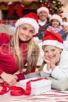 Festive mother and daughter opening christmas present