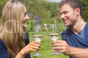 Cute couple toasting with white wine