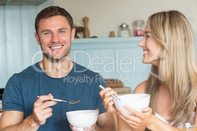 Cute couple having cereal for breakfast