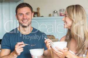 Cute couple having cereal for breakfast