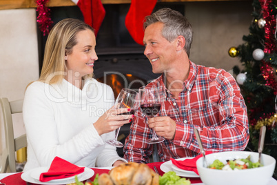 Couple toasting each other with red wine