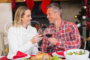 Couple toasting each other with red wine