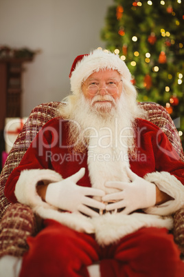 Portrait of happy santa holding his belly