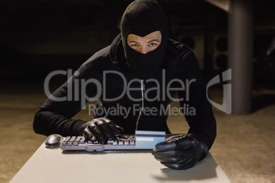 Burglar shopping online with laptop