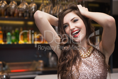 Seductive brunette posing for camera ruffling her hair