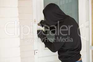 Burglar breaking open the door