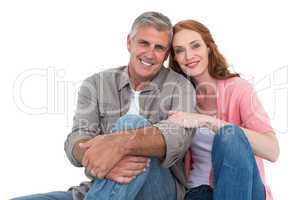 Casual couple sitting and smiling