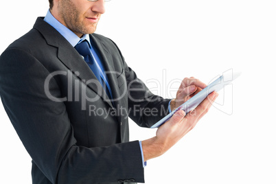 Mid section of a businessman using digital tablet