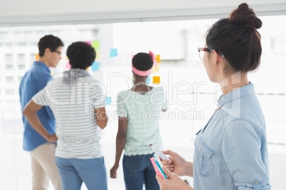 Young creative woman looking at team