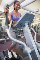 Fit woman working out on the cross trainer
