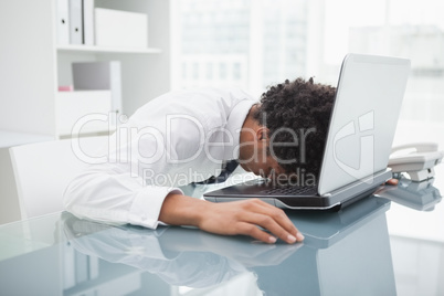 Businessman sleeping on his laptop