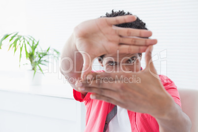 Businessman posing with hands making a frame